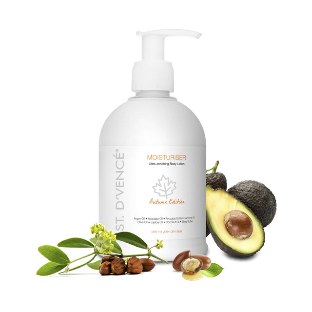St. D’vence Autumn Edition Body Moisturiser with Argan Oil & Avocado Butter, 300 ml with freshly cut Avocado fruit and Argan seeds around the bottle.